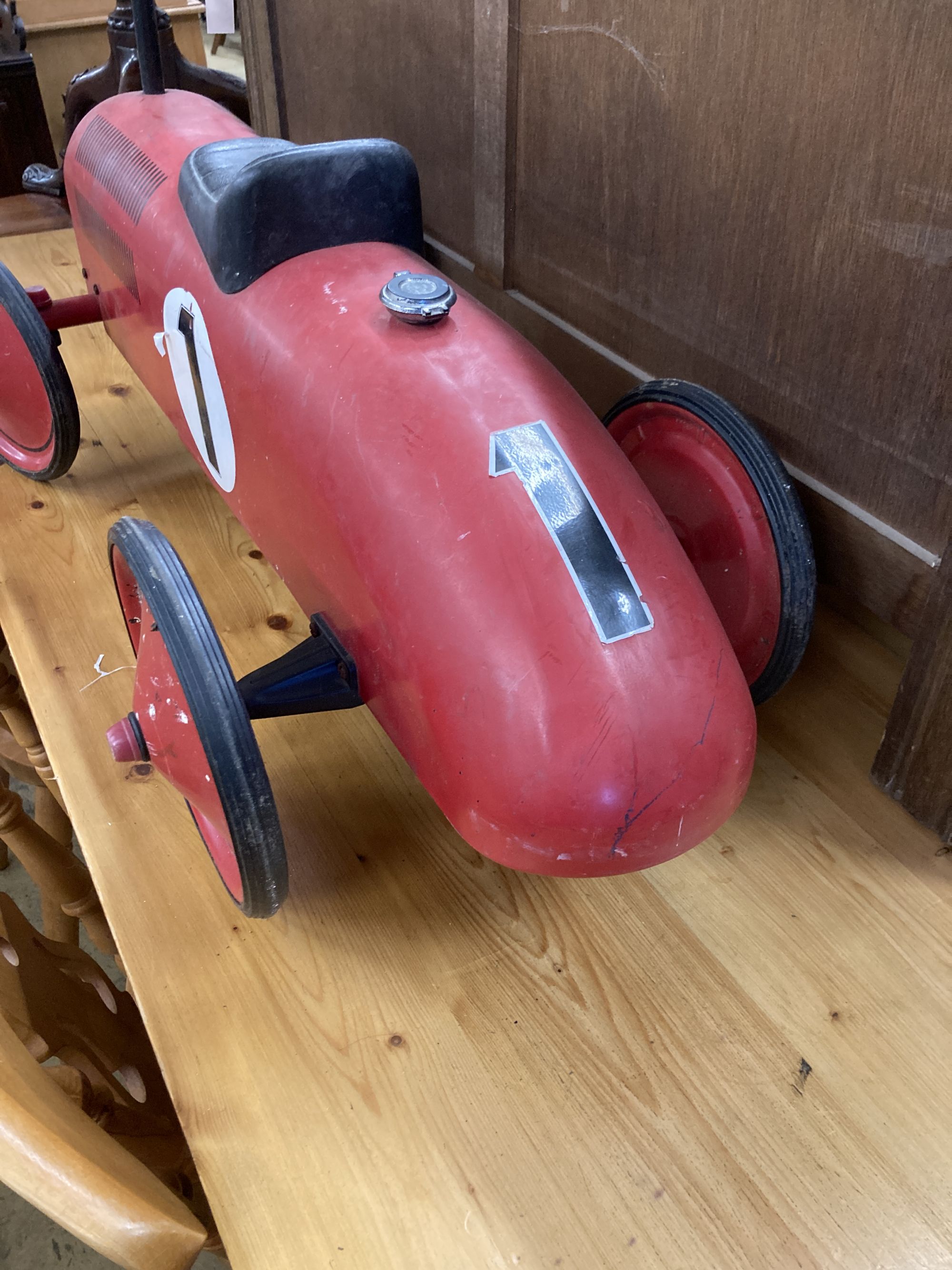 A child's vintage style painted metal sit on toy racing car, length 76cm